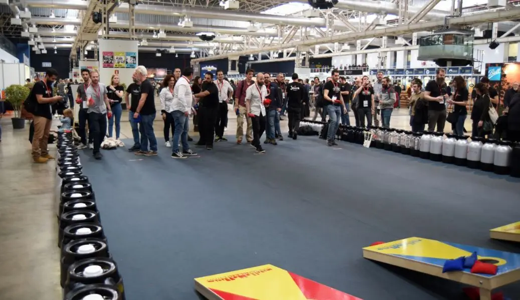 People playing cornhole during brand activation at an event